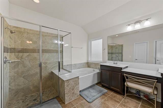 full bath featuring vaulted ceiling, a stall shower, and a bath