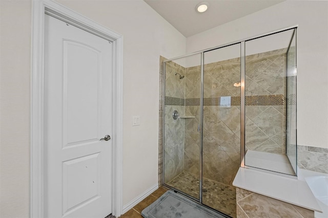 full bath featuring a stall shower and tile patterned floors