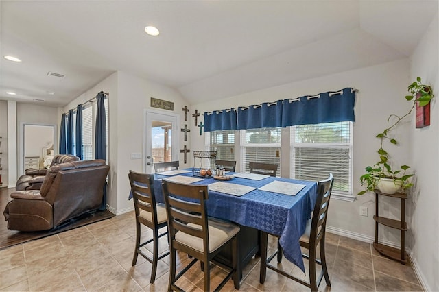 tiled dining area featuring lofted ceiling, visible vents, baseboards, and recessed lighting