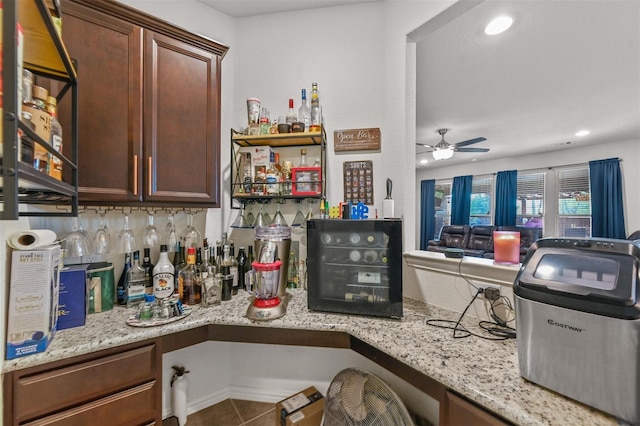 kitchen with recessed lighting, light stone countertops, ceiling fan, and tile patterned floors