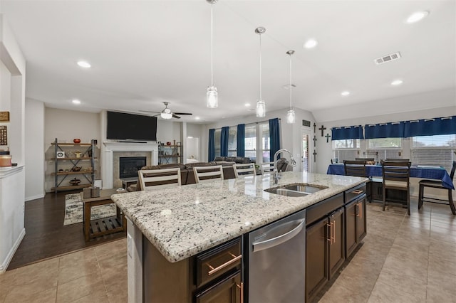 kitchen featuring visible vents, open floor plan, a sink, a kitchen island with sink, and stainless steel dishwasher