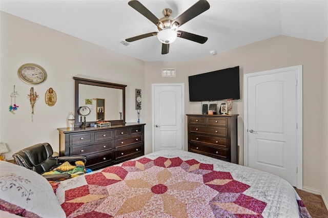 carpeted bedroom with lofted ceiling, visible vents, and a ceiling fan