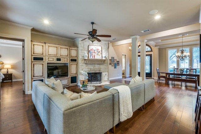 living area with dark wood-type flooring, visible vents, ornamental molding, and ornate columns