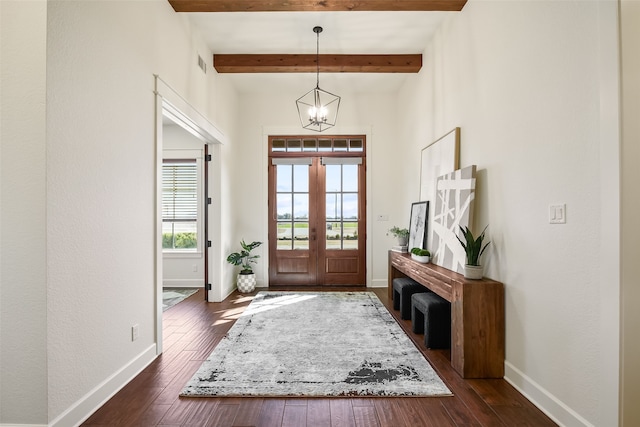 foyer entrance featuring dark wood-style floors, beam ceiling, and baseboards