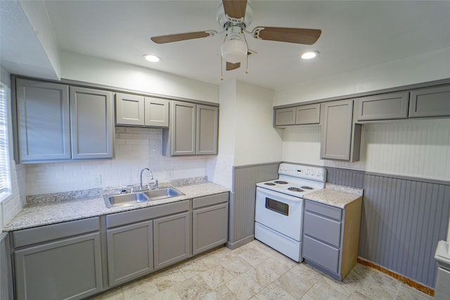 kitchen with a sink, white electric range, light countertops, and gray cabinetry