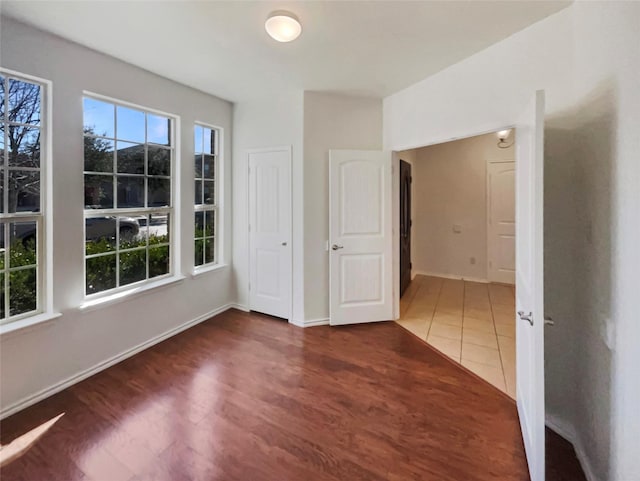 interior space with dark wood finished floors and baseboards