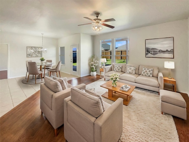 living area with ceiling fan and wood finished floors