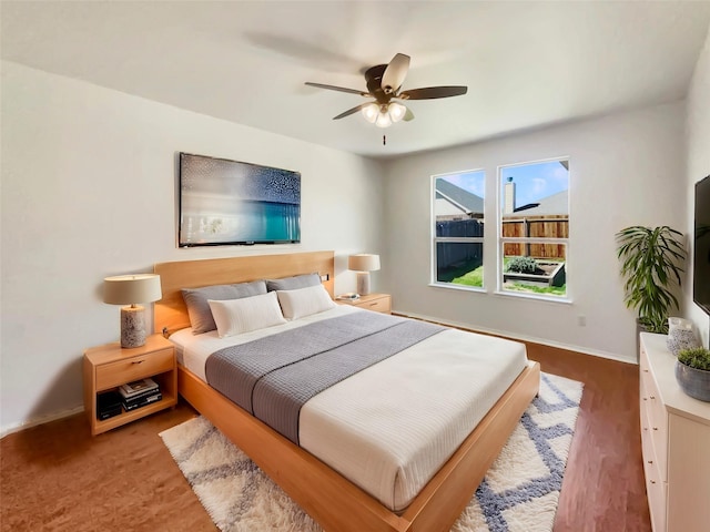 bedroom with a ceiling fan and baseboards