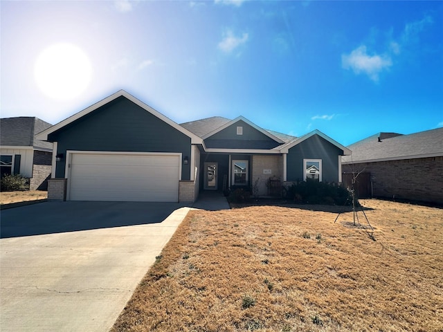 ranch-style house featuring brick siding, driveway, and an attached garage