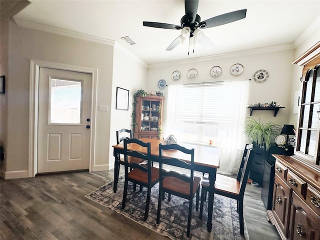 dining room featuring baseboards, visible vents, dark wood finished floors, and ornamental molding