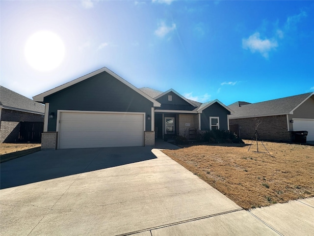 single story home featuring concrete driveway, brick siding, and an attached garage