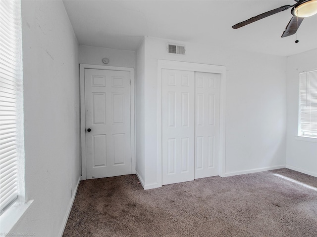 unfurnished bedroom featuring visible vents, baseboards, a closet, and carpet flooring