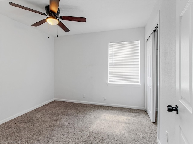 unfurnished bedroom with baseboards, carpet floors, a closet, and ceiling fan