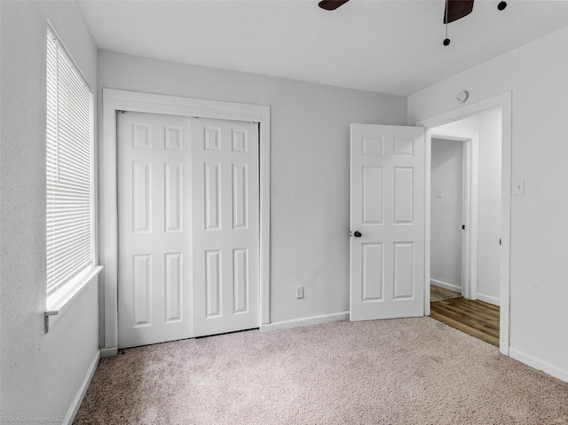 unfurnished bedroom featuring carpet, a closet, and baseboards