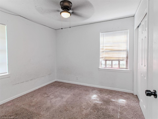 spare room with baseboards, a textured ceiling, and ceiling fan