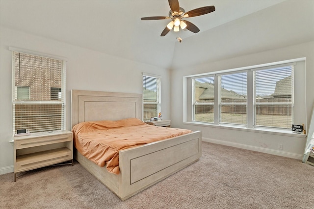 bedroom with light carpet, lofted ceiling, a ceiling fan, and baseboards