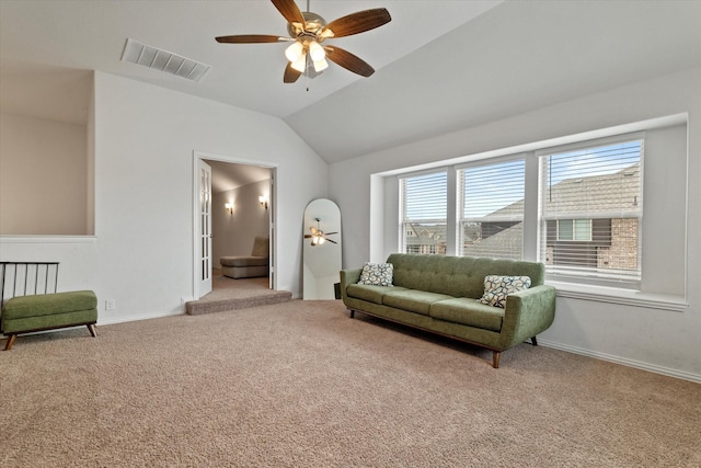 sitting room featuring visible vents, vaulted ceiling, light carpet, and baseboards