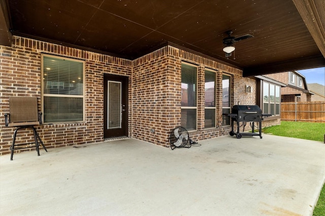 view of patio with fence, grilling area, and ceiling fan