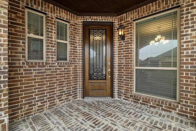 property entrance featuring brick siding