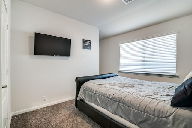 carpeted bedroom with lofted ceiling, visible vents, and baseboards