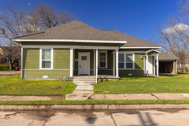 bungalow with a shingled roof, crawl space, and a front lawn