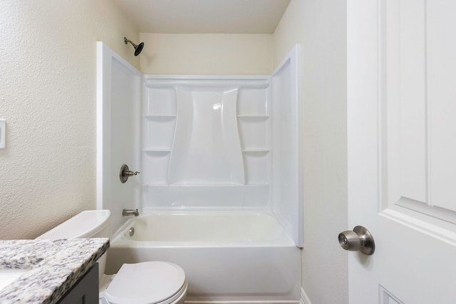 bathroom with a textured wall, vanity, toilet, and shower / bathtub combination