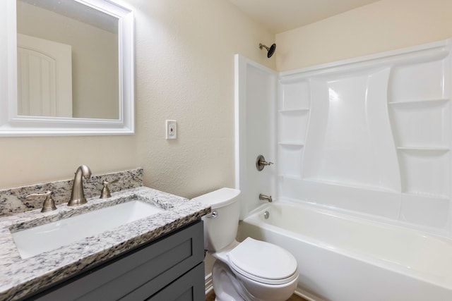 bathroom featuring toilet, a textured wall, washtub / shower combination, and vanity