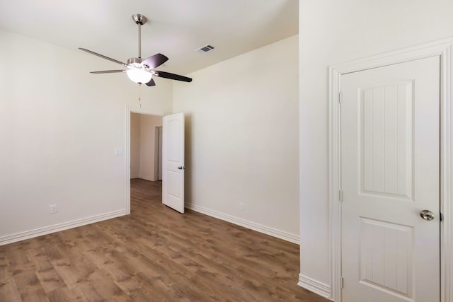 unfurnished bedroom featuring ceiling fan, wood finished floors, visible vents, and baseboards