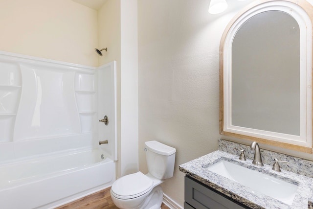 bathroom featuring vanity, wood finished floors, shower / tub combination, and toilet