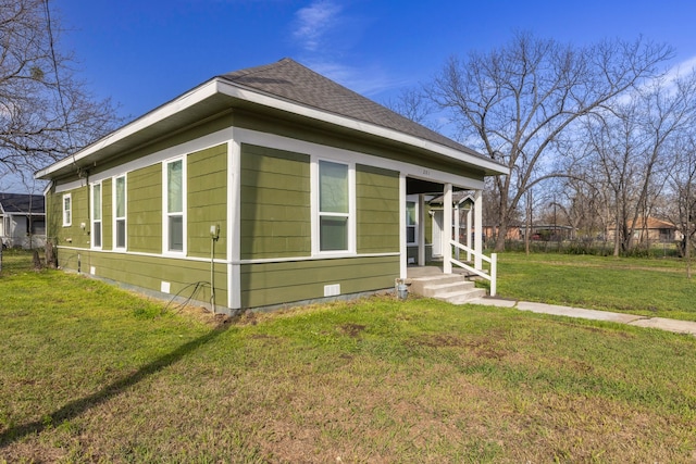 view of front of property with roof with shingles, crawl space, and a front yard