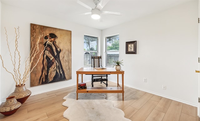 home office featuring ceiling fan, baseboards, and light wood-style floors