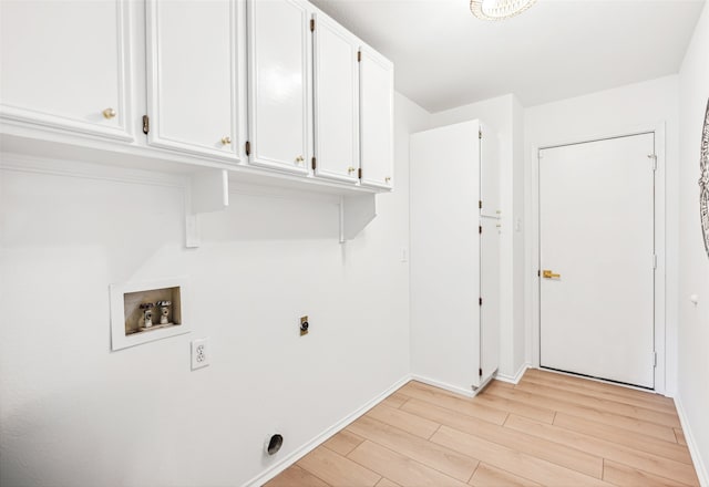 washroom with hookup for a washing machine, cabinet space, light wood-style flooring, hookup for an electric dryer, and baseboards