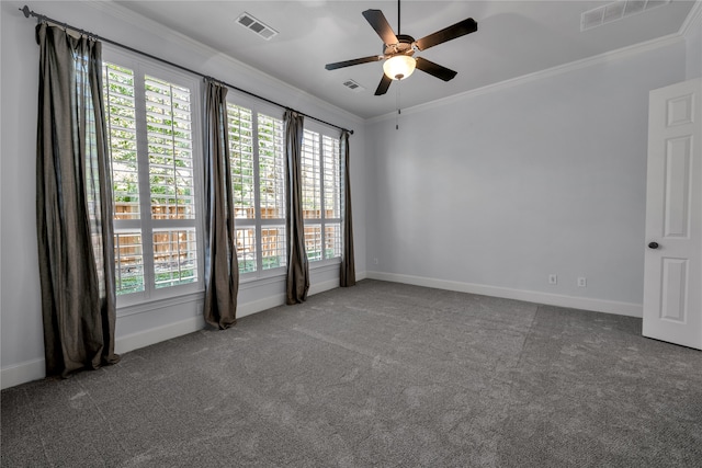 carpeted spare room featuring baseboards, visible vents, and crown molding