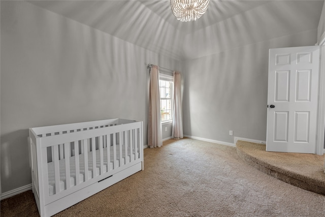 unfurnished bedroom featuring a chandelier, carpet, and baseboards