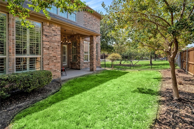 view of yard featuring a patio area and a fenced backyard