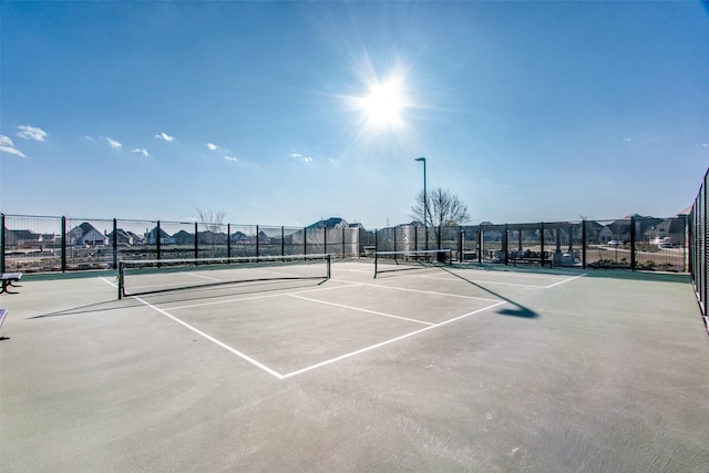 view of tennis court with fence