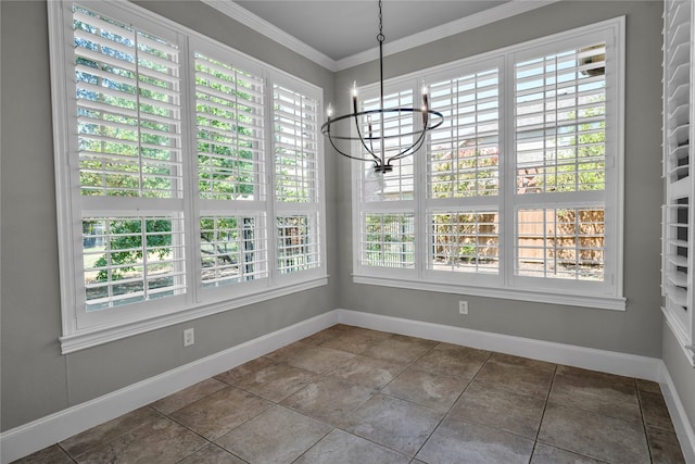 unfurnished dining area with an inviting chandelier, crown molding, baseboards, and a wealth of natural light