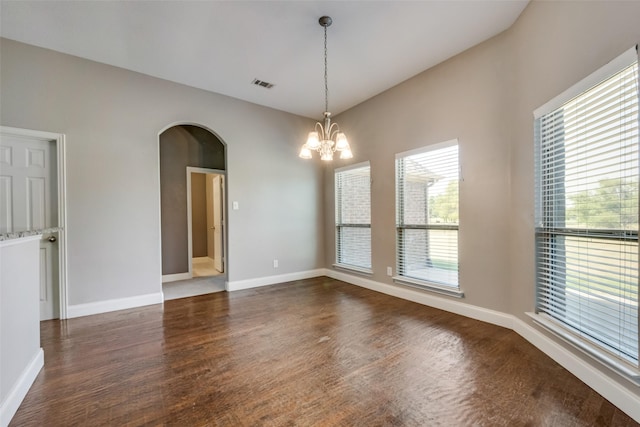 unfurnished room featuring baseboards, visible vents, arched walkways, and dark wood-type flooring