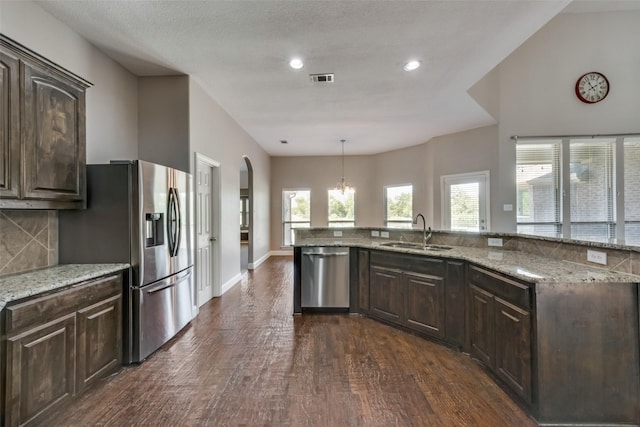 kitchen with dark wood-style floors, appliances with stainless steel finishes, dark brown cabinets, and a sink