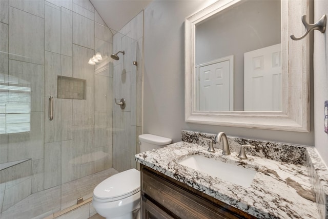 full bath with toilet, lofted ceiling, vanity, and a shower stall