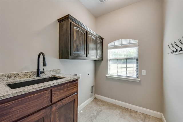 laundry area with hookup for an electric dryer, a sink, visible vents, baseboards, and cabinet space