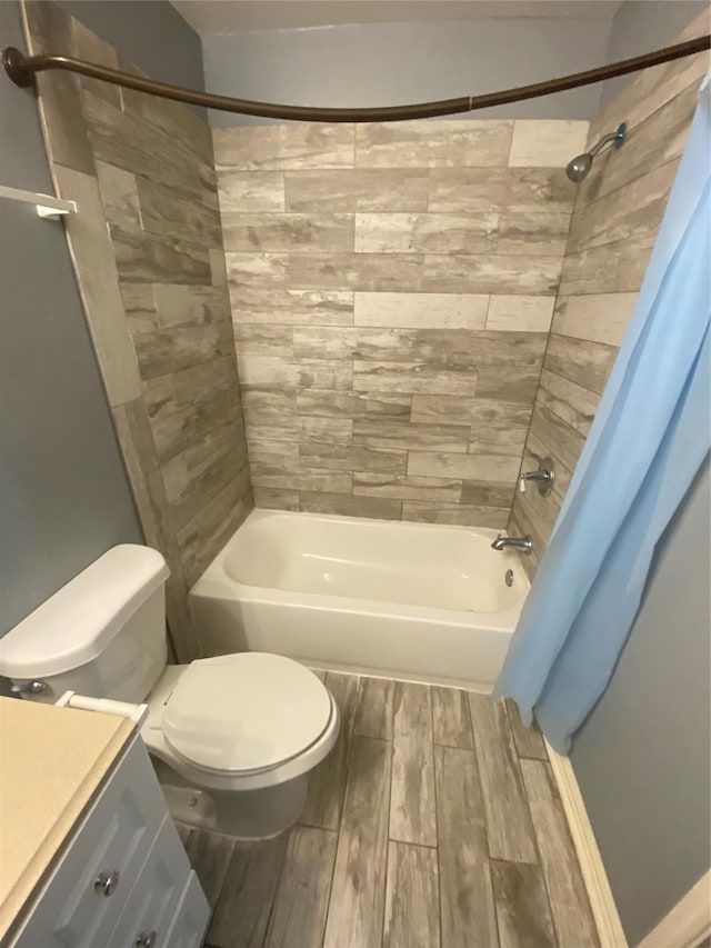 full bathroom with toilet, wood tiled floor, and vanity