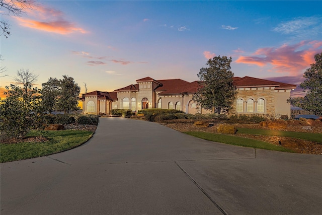 mediterranean / spanish-style home featuring concrete driveway