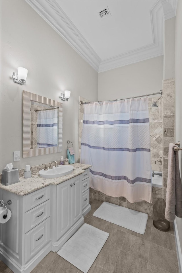 full bath featuring tile patterned floors, visible vents, ornamental molding, and vanity