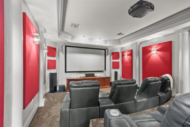 home theater room featuring a tray ceiling, decorative columns, visible vents, and crown molding