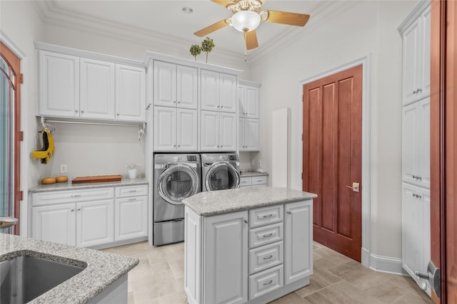 washroom with cabinet space, ornamental molding, a ceiling fan, and independent washer and dryer