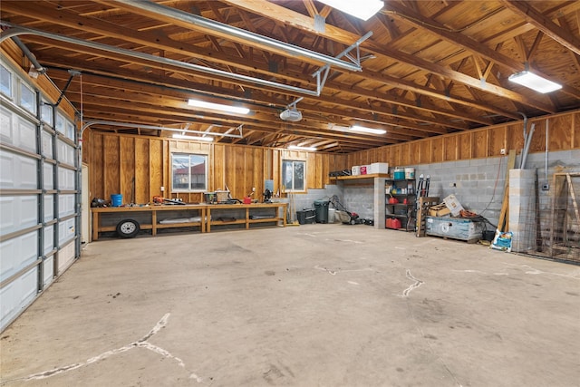 garage featuring a workshop area and concrete block wall