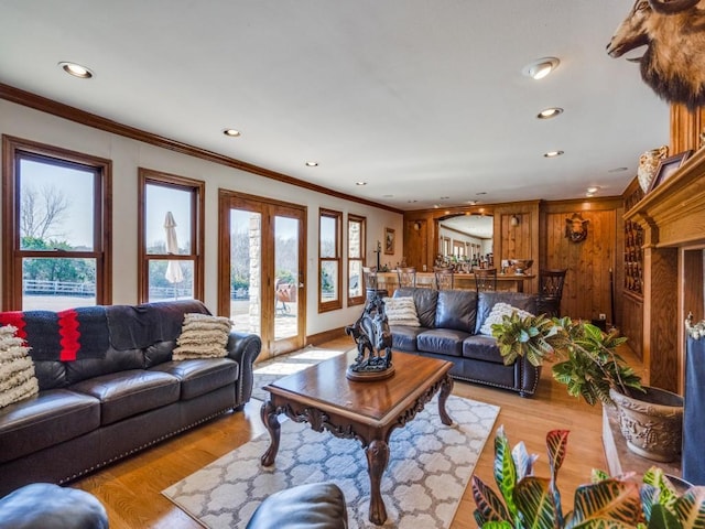 living area featuring recessed lighting, light wood-style floors, french doors, and ornamental molding