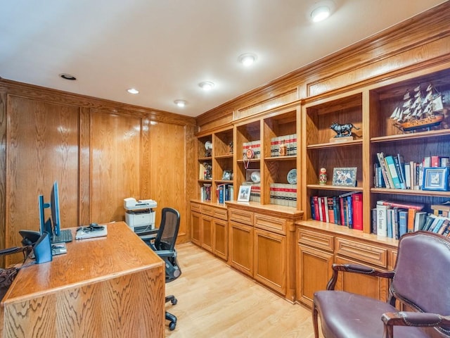 office area with light wood-style flooring, recessed lighting, and wood walls