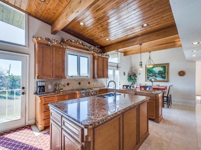 kitchen featuring a sink, brown cabinets, tasteful backsplash, and wooden ceiling